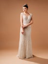 Beautiful happy bride in a trumpet wedding dress. Fashionable bridal gown with tender french lace, deep front slit on decollete