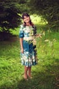 Beautiful happy brunette woman in the park on a warm summer day Royalty Free Stock Photo