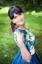 Beautiful happy brunette woman in the park on a warm summer day Royalty Free Stock Photo