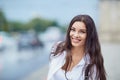 Beautiful happy brunette woman smiling outdoors on city street. Royalty Free Stock Photo