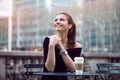 Beautiful happy businesswoman sitting in city park during lunch time or coffee break with paper coffee cup. Royalty Free Stock Photo