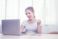 Beautiful happy caucasian woman in casual communicate via computer by video chat in living room.Work at home,stay at home and Royalty Free Stock Photo