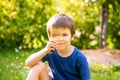 Beautiful happy child, boy, exploring nature with magnifying glass, summertime Royalty Free Stock Photo