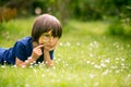 Beautiful happy child, boy, exploring nature with magnifying glass, summertime Royalty Free Stock Photo