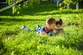 Beautiful happy children, boy brothers, exploring nature with magnifying glass, summertime Royalty Free Stock Photo