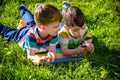 Beautiful happy children, boy brothers, exploring nature with magnifying glass, summertime Royalty Free Stock Photo