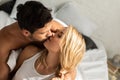 Happy couple kissing in bed in the morning Royalty Free Stock Photo