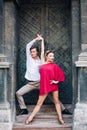 Beautiful happy couple in love embracing and dancing at old building in sunny street. stylish hipster groom and blonde bride in Royalty Free Stock Photo