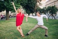 Beautiful happy couple in love embracing and dancing in sunny street. stylish hipster groom and blonde bride performing dance, Royalty Free Stock Photo