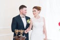 A beautiful happy couple in the registry office performs a wedding ritual with candle lighting. Royalty Free Stock Photo