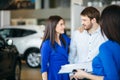 Beautiful happy couple standing near their new car Royalty Free Stock Photo