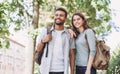 Beautiful happy couple summer portrait. Young joyful smiling woman and man in a city. Love, travel, tourism, students concept