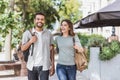 Beautiful happy couple summer portrait. Young joyful smiling woman and man walking in a city. Royalty Free Stock Photo