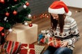 Beautiful happy emotional woman in red santa hat and reindeer sw Royalty Free Stock Photo