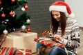 Beautiful happy emotional woman in red santa hat and reindeer sw Royalty Free Stock Photo