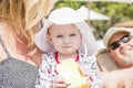 Beautiful Happy Expressive Blond Girl Toddler on the Beach with her Grandparents