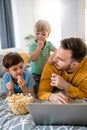 Beautiful happy family with child looking at laptop with cheerful smile Royalty Free Stock Photo