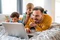 Beautiful happy family with child looking at laptop with cheerful smile Royalty Free Stock Photo