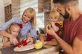 Mother and father preparing dinner with their children Royalty Free Stock Photo