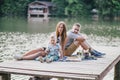 Beautiful happy family having picnic near lake Royalty Free Stock Photo