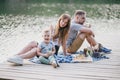 Beautiful happy family having picnic near lake Royalty Free Stock Photo