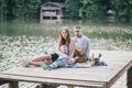 Beautiful happy family having picnic near lake Royalty Free Stock Photo