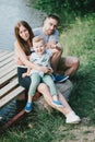 Beautiful happy family having picnic near lake Royalty Free Stock Photo