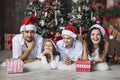 Beautiful happy family mother, father, son, and daughter to celebrate Christmas and new year together at home Royalty Free Stock Photo