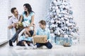 Beautiful happy family mother, father, son, and daughter to celebrate Christmas and new year together at home Royalty Free Stock Photo