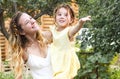 Beautiful happy family of mother and little daughter under summer rain in green garden Royalty Free Stock Photo