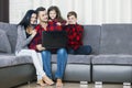 Beautiful happy family portrait at home sitting together on sofa Royalty Free Stock Photo