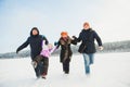 Beautiful happy family running together in winter Royalty Free Stock Photo