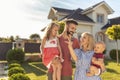 Family holding keys after buying a new house Royalty Free Stock Photo