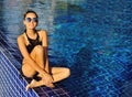 Beautiful happy female model posing by the pool, outdoor summer Royalty Free Stock Photo