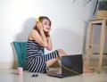 beautiful and happy freelancer girl using laptop computer working relaxed listening to music at home or office floor looking cool Royalty Free Stock Photo