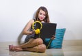 beautiful and happy freelancer woman using laptop computer working relaxed sitting at home floor or office ground cool and Royalty Free Stock Photo