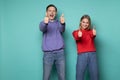 Beautiful happy friends boy and girl in casual clothes showing thumbs up and looking at the camera Royalty Free Stock Photo