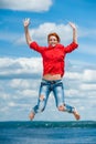 Beautiful happy funny young redhead woman jumps