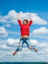 Beautiful happy funny young redhead woman jumps