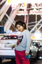 Beautiful happy girl with the background of an amusement park. Royalty Free Stock Photo