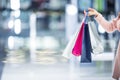 Beautiful happy girl with credit card and shopping bags in shopping mall. Shopping Center in the background. Royalty Free Stock Photo