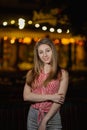 Beautiful happy girl in the evening in the park stands with burning lanterns. Royalty Free Stock Photo