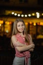 Beautiful happy girl in the evening in the park stands with burning lanterns. Royalty Free Stock Photo