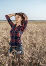 Beautiful happy girl in the field, sunny afternoon, shorts shirt. The concept of enjoying nature. Rest on the air Royalty Free Stock Photo