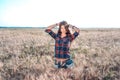 Girl in a field shirt shorts, wheat outdoor recreation, beautiful hair. Corrects hair. Royalty Free Stock Photo