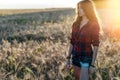 Beautiful happy girl in the field, sunny afternoon, shorts shirt. The concept of enjoying nature. Rest on the air Royalty Free Stock Photo