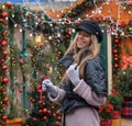 Beautiful happy girl model holding sparkler on the background of the Christmas house.Holiday concept Royalty Free Stock Photo