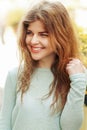 Beautiful happy girl posing and smiling in soft sunny light in city street, joyful moments, true emotions Royalty Free Stock Photo