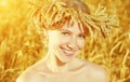 Beautiful happy girl in wreath in wheat field in summer Royalty Free Stock Photo