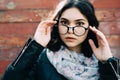 Beautiful happy hipster girl goes in the city. Closeup of trendy girl face. Royalty Free Stock Photo